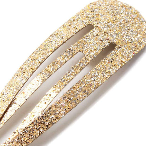 Gold glitter sleepies and 2 star elastics on a card.